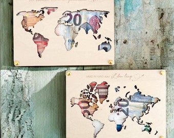 May include: Two wooden world maps with cutouts filled with euro bills. The top map has the text "DER schönste WEG IST DER gemeinsame" and the bottom map has the text "HAND IN HAND ein Leben lang".