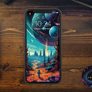Könnte beinhalten: Ein schwarzes Smartphone mit einer farbenfrohen Weltraum-Tapete. Die Tapete zeigt einen großen Planeten mit Ringen, einen kleineren Planeten und einen sternenübersäten Hintergrund. Die Uhrzeit wird als 10:24 angezeigt und das Datum ist Dienstag, der 8. September.
