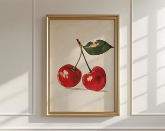 Könnte beinhalten: Ein gerahmter Kunstdruck mit zwei reifen roten Kirschen und einem grünen Blatt. Die Kirschen sind mit Glanzlichtern und Schatten gemalt, vor einem cremefarbenen Hintergrund. Der Rahmen ist goldfarben.