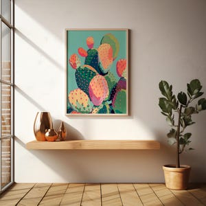 a painting of a cactus on a shelf next to a potted plant