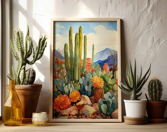 May include: A framed watercolor painting of a desert landscape with tall cacti, blooming flowers, and rocks. The painting is in a light wood frame and is hanging on a white wall.