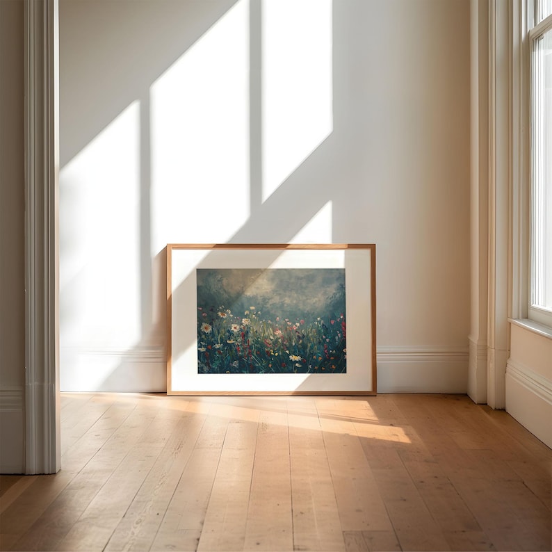 an empty room with a picture frame on the floor
