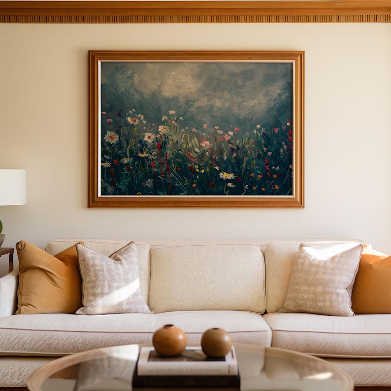 a living room with a couch and a painting on the wall