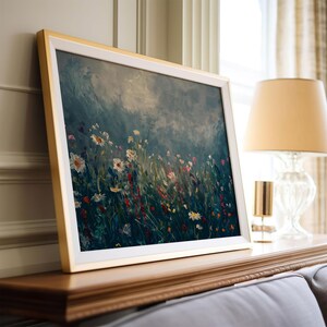 a picture of a painting on a mantle next to a lamp