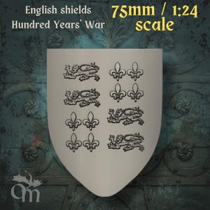 May include: A cream-coloured shield featuring black heraldic designs of lions and fleur-de-lis. The text at the top reads "English shields Hundred Years' War" and "75mm / 1:24 scale". The shield is a historical item.