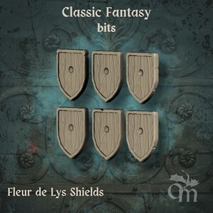 May include: Six light brown Fleur de Lys shields with a wood grain design. Each shield has a central circular detail. The text "Classic Fantasy bits" and "Fleur de Lys Shields" are visible in the image.
