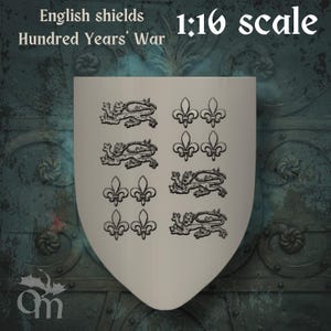 May include: A cream-coloured shield featuring black heraldic designs, including lions and fleur-de-lis. The text "English shields Hundred Years' War" and "1:16 scale" are displayed at the top. The shield is a historical replica.