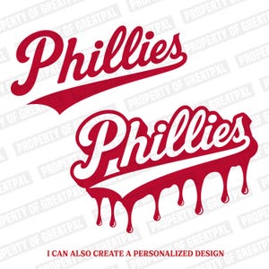 May include: Two graphic designs featuring the word Phillies in a red script font. The top design is a standard script, while the bottom design features a dripping paint effect below the text. The text I CAN ALSO CREATE A PERSONALIZED DESIGN appears.