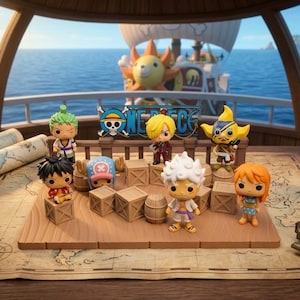 May include: A collection of seven One Piece character figurines arranged on a wooden platform with small crates and a barrel. The figures feature stylized large heads and small bodies. A sign with the text One Piece is positioned behind the figures.