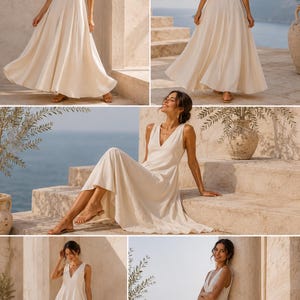May include: A floor-length, sleeveless cream-colored dress featuring a deep V-neckline, a fitted bodice, and a full, flowing skirt. The garment is constructed with a solid, light-colored fabric that drapes loosely from the waist to the hemline.