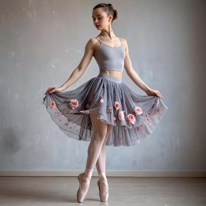 May include: A grey two-piece outfit consisting of a sleeveless crop top and a high-waisted, knee-length tulle skirt. The skirt features a layered, sheer grey fabric adorned with multiple three-dimensional pink fabric roses scattered across the hem.