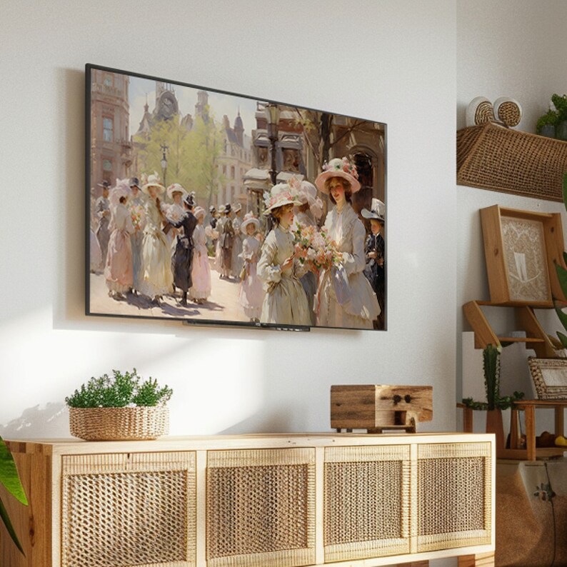May include: A framed painting of women in hats walking down a street in a city. The painting is in a modern, minimalist living room setting, hanging on a white wall above a wooden cabinet with wicker doors.