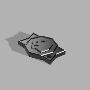 Könnte beinhalten: Ein schwarzer Schlüsselanhänger aus Metall mit einem stilisierten Totenkopfdesign.