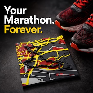 May include: A square 3D map plaque featuring a black base with raised yellow and red street patterns, accompanied by a pair of black and red running shoes. The text "Your Marathon. Forever." is printed in white and yellow on the dark background.