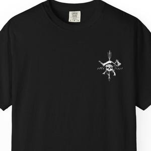 May include: Black t-shirt with a white graphic on the front. The graphic features a skull, crossed axes, an arrow, and the words "Park Tides". The shirt has a crew neck and short sleeves.