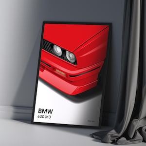May include: A framed poster featuring a red BMW e30 M3 with the text "BMW e30 M3 1986-1991".