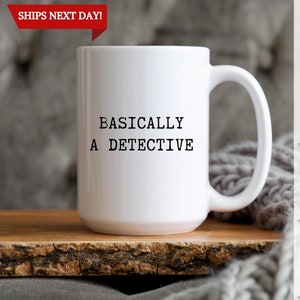 May include: White ceramic coffee mug with a black text design that reads "BASICALLY A DETECTIVE".