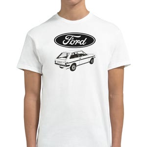Może przedstawiać: Biała koszulka z czarnym logo Forda i czarno-białym rysunkiem samochodu Forda.
