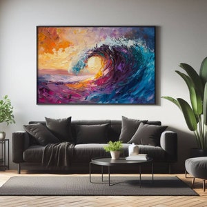 May include: Large framed abstract painting of a breaking ocean wave. The artwork features vibrant colors including orange, yellow, purple, and blue. The painting is displayed above a dark gray sofa in a living room setting.