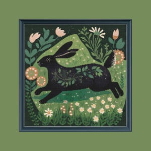 May include: Cross-stitch art of a black rabbit running through a field of flowers. The rabbit has leaf-like details and is surrounded by white and peach-colored flowers, all within a dark green frame.