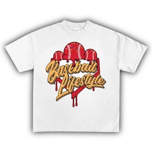 May include: White t-shirt featuring a baseball-themed graphic. The design includes three red baseballs with white stitching, dripping over a red and yellow stylized text that reads "Baseball Lifestyle".
