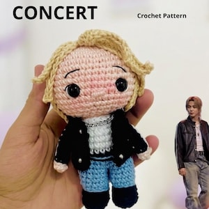 May include: A crocheted doll of a person wearing a black jacket, blue jeans, and black shoes. The doll has blonde hair and large black eyes. The text "PARK JIMIN CONCERT" and "Crochet Pattern" are visible.