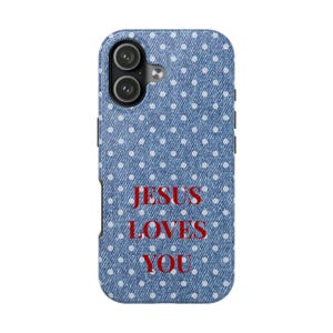 May include: A blue phone case with a denim-like texture and white polka dots. The case features the text "JESUS LOVES YOU" in red. The phone case has a dual-lens camera cutout.