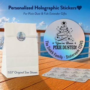 May include: Round holographic stickers featuring a black graphic of a Christmas tree with stars and the text "You've Been PIXIE DUSTED! The Smith Family - Stateroom 12345". The stickers are shown on a white paper bag and a sheet, with 1.03" size noted.