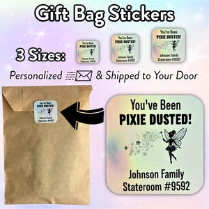 May include: Three iridescent holographic stickers with the text "You've Been Pixie Dusted!" and a fairy design. The stickers are personalised with a name and stateroom number. The stickers are shown on a brown paper gift bag.