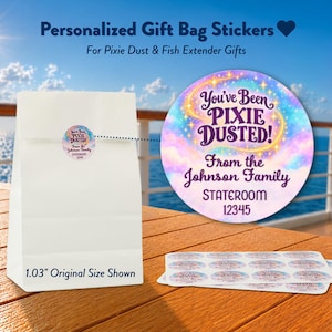 May include: A white paper gift bag with a round sticker featuring a pastel galaxy background, gold sparkles, and the text You've Been PIXIE DUSTED! From the Johnson Family STATEROOM 12345. A sheet of identical 1.03 inch round stickers is included.