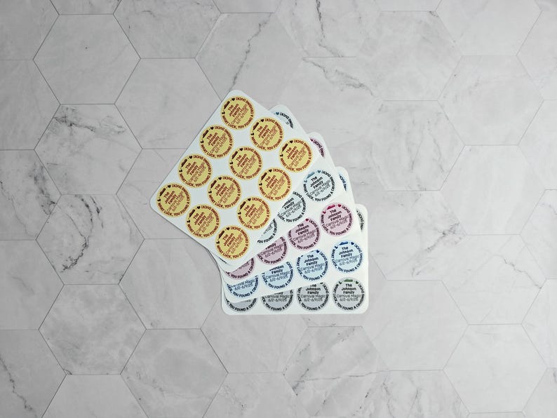 May include: Three sheets of round stickers with different designs. The top sheet has yellow stickers with red text. The middle sheet has pink stickers with black text. The bottom sheet has blue stickers with white text.