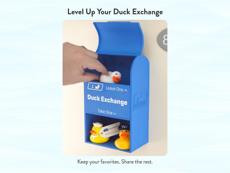 May include: A blue Duck Exchange box with the text "Duck Exchange" and "Leave One" and "Take One". The box contains rubber ducks, including a white duck and a yellow duck wearing a sailor hat. The text "Level Up Your Duck Exchange" is at the top.