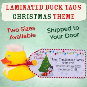 May include: A yellow rubber duck wearing a white sailor hat and a red bow tie, next to a Christmas-themed tag. The tag features a Christmas tree, snowman, and text that reads "Merry Christmas" and "From The Johnson Family". The image also includes the text "Laminated Duck Tags Christmas Theme".