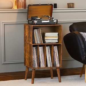 May include: A brown wooden record player stand with four shelves. The stand has a vintage look and is perfect for storing and displaying vinyl records. The stand has four legs and is about 30 inches tall.