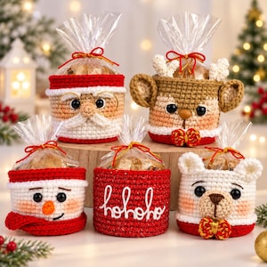 May include: Five crochet gift baskets featuring holiday designs: a Santa Claus with glasses, a reindeer with antlers, a snowman with a scarf, a red basket with white hohoho text, and a white bear with a bow, all tied with clear plastic.