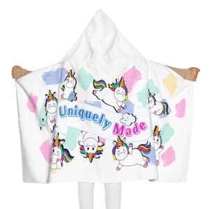 May include: White hooded towel with a colorful unicorn design and the text "Uniquely Made".
