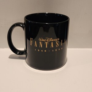 May include: Black ceramic mug with a gold inscription that reads "Walt Disney's Fantasia 1940 - 1990".