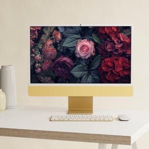 A set of dark, moody floral desktop wallpapers featuring richly detailed blossoms in deep, dramatic tones. The collection includes close-up compositions of roses, anemones, and layered petals in shades of crimson, blush pink, ivory, and cool blue, set against shadowy foliage. Soft lighting and subtle highlights create a cinematic, almost velvety texture, with hints of mist and glow adding depth and atmosphere.