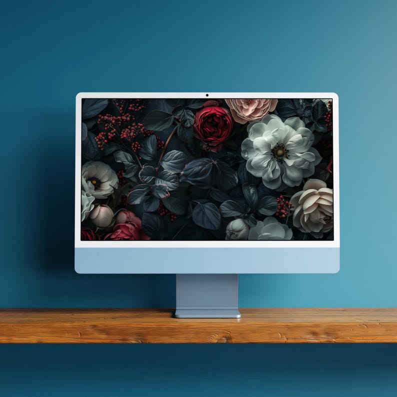 A set of dark, moody floral desktop wallpapers featuring richly detailed blossoms in deep, dramatic tones. The collection includes close-up compositions of roses, anemones, and layered petals in shades of crimson, blush pink, ivory, and cool blue, set against shadowy foliage. Soft lighting and subtle highlights create a cinematic, almost velvety texture, with hints of mist and glow adding depth and atmosphere.