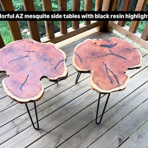 May include: Two side tables made from natural mesquite wood slabs with irregular edges and black resin inlay filling the cracks. Each table features three thin black metal hairpin legs. The text Colorful AZ mesquite side tables with black resin highlights is visible.