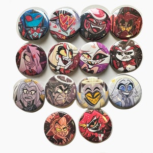 May include: A set of 13 round buttons featuring various characters from the animated series "Hazbin Hotel". The buttons are colorful and feature characters like Angel Dust, Charlie, and Alastor.