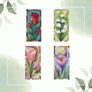 May include: Four stained glass style bookmarks featuring different flowers. The bookmarks are rectangular and have a colorful border. The flowers include a red rose, white lily of the valley, purple tulips, and a purple crocus.