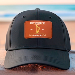 May include: Black baseball cap with a brown patch featuring the text "Limerick, Est. 1922, Ireland" and a gold harp graphic.