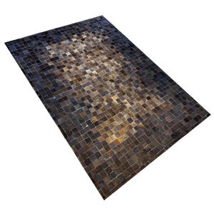May include: Rectangular rug with a mosaic pattern. The rug has a patchwork design of small, square tiles in shades of brown, black, and tan. The colour gradient shifts from dark edges to a lighter centre, creating a textured appearance.