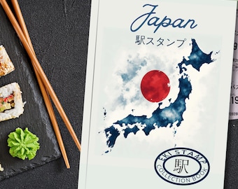 May include: A white book cover with the word "Japan" in cursive and Japanese text. The cover features a watercolor map of Japan in blue with a red circle representing the flag. An oval logo reads "EKI STAMP COLLECTION BOOK".