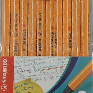May include: A package of ten Stabilo point 88 fineliner pens in various colors. The pens have orange barrels and black tips, with a 0.4 mm line width. The packaging includes the Stabilo logo and website.