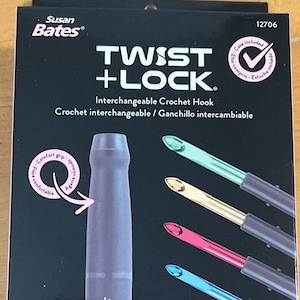 May include: A box set of Susan Bates Twist + Lock interchangeable crochet hooks. The set includes a purple handle, multiple hook sizes with colored tips, and a case. The box features the text "Interchangeable Crochet Hook".