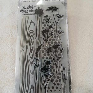 May include: A clear sheet of stamps and stencils featuring a wood grain pattern, a polka dot pattern, and various floral designs. The sheet is labeled "Jin Holley Collection Stamps/Stencil" and "Stampers Anonymous".