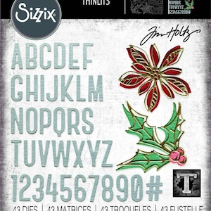 May include: A set of 43 metal dies for crafting, featuring a full alphabet, numbers, and holiday-themed designs. The dies are silver-colored and include a poinsettia flower, holly leaves, and a Christmas tree. The set is labeled "Thinlits" and "Sizzix" and includes the designer's name, "Jim Holtz".