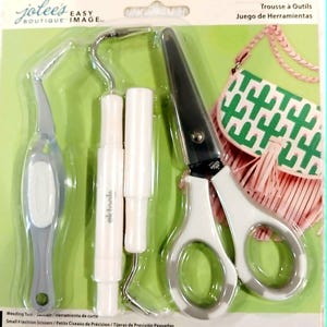 May include: A tool kit with various craft tools, including small scissors, tweezers, and a hook tool. The tools have white and gray handles and are packaged on a green and white background. The kit includes the text "Jolee's Easy Boutique Image."